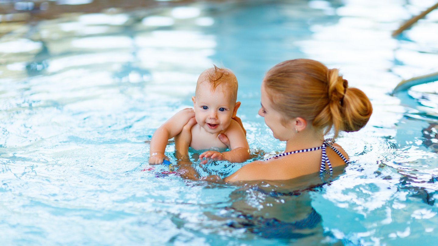 Frau mit Baby im Wasser